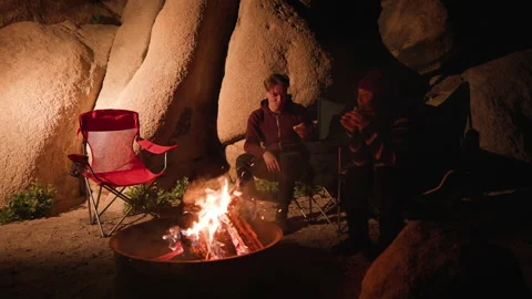 Beautiful couple having dinner by the campfire during adventurous weekend trip Stock Footage 237920188