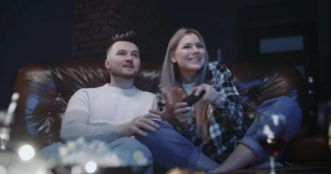 Beautiful couple having fun playing video games in front of tv in evening Stock Footage 147363466