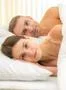 The beautiful couple lay on the bed Photo