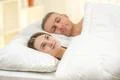 The beautiful couple lay on the bed Photo