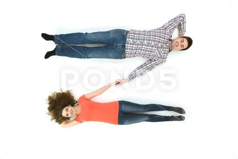 The beautiful couple lay on the white background. View from above Stock Photos