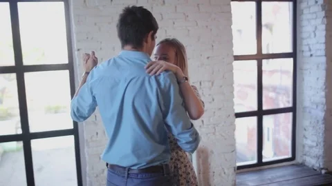 Beautiful couple in love is learning to dance in the studio Stock Footage 70200022