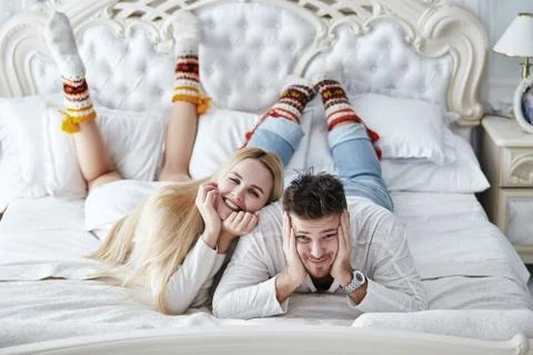Beautiful couple is lying in the bed Stock Photos