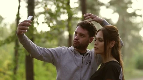 Beautiful couple makes faces at the camera in the phone. Stock Footage 141921212