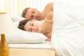 The beautiful couple sleeping on the bed Photo