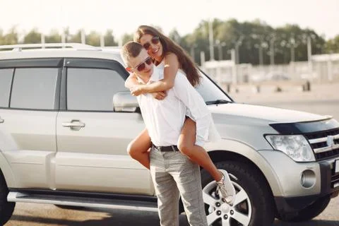 Beautiful couple spend time in a summer park near a car Foto stock