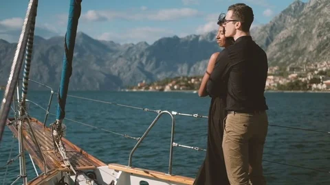 Beautiful couple stand on deck of moving ship in summer Video stock 76233441
