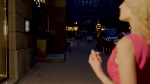 Beautiful couple strolling through evening market street looking at shop windows 스톡 동영상 80657159