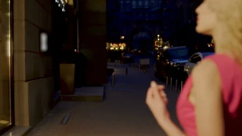 Beautiful couple strolling through evening market street looking at shop windows 스톡 동영상 80663487