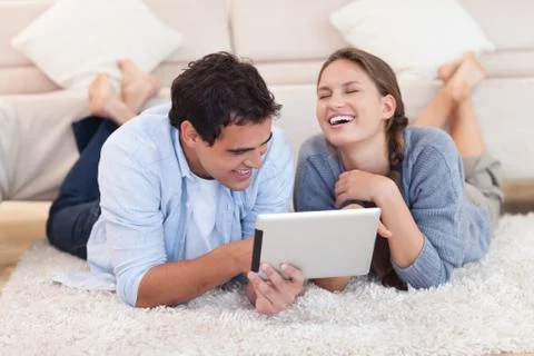 Beautiful couple using a tablet computer 写真素材
