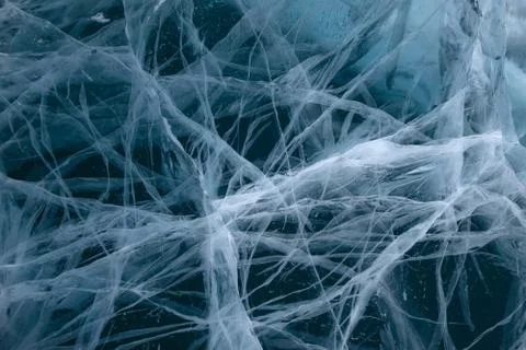 Beautiful cracks in the ice structure or texture in blue tones Stock Photos