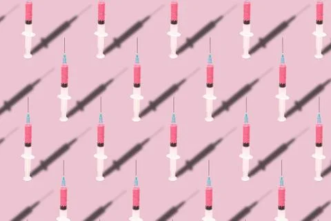 Beautiful creative pattern syringe medical on a pink background. Coronavirus  Illustrazione stock