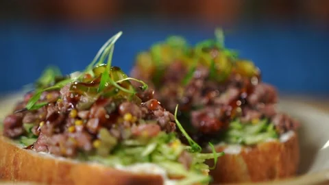Beautiful crispy bruschetta baked bread are laid out on plate in the restaurant Stock Footage 141419701
