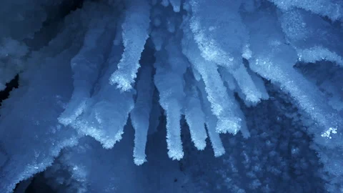 Beautiful crystal icicles, blue sharp ice floes inside frozen grotto Vídeo Stock 179762910