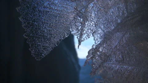 Beautiful crystal icicles, blue sharp ice and snowflakes inside frozen cave Stock Footage 179868421