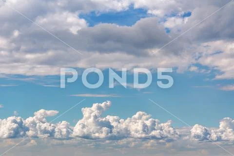 Beautiful cumulus clouds in a blue sky Stock Photos