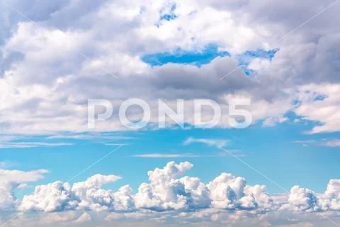 Beautiful cumulus clouds in a blue sky Stock Photos