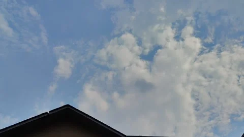 Beautiful cumulus clouds drifting across a bright blue sky Stock Footage 319055320