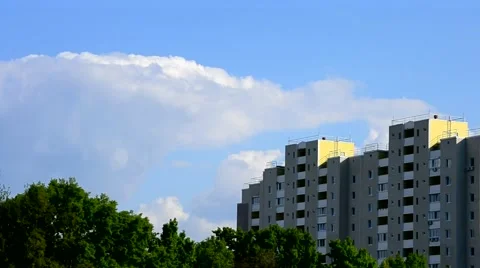 Beautiful cumulus clouds move behind modern apartment block Stock Footage 50962131