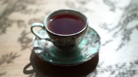 Beautiful cup with black tea is on the table. Steam comes from the cup Stock Footage 133999755
