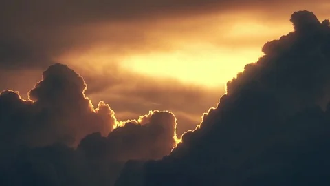 Beautiful curling orange sunset clouds and flying airplane with contrail time Stock Footage 76035615