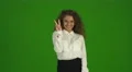 The beautiful curly woman gesture and stand on the green background. Real time 4k or 4k+ Resolution