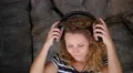 Beautiful Curly Woman Listening to Music in Headphones. Slow Motion. HD Footage