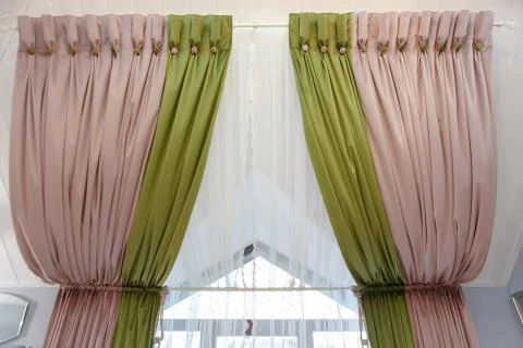 Beautiful curtains on the window under the ceiling. Stock Photos
