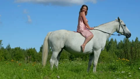 Beautiful curvy female model posing and smiling on a horse Stock Footage 145754955
