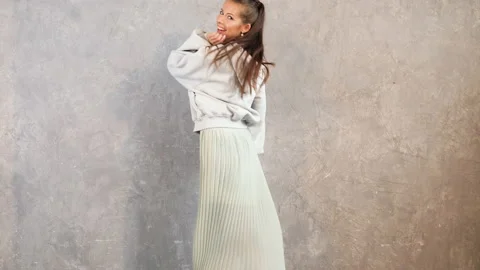 Beautiful cute smiling model dancing and playing with dress 動画素材 140896017