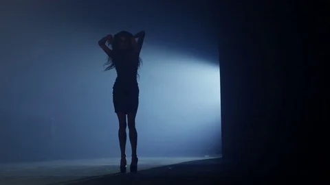 Beautiful dancer demonstrating her perfect figure and dancing on dark background Vidéo 72194175