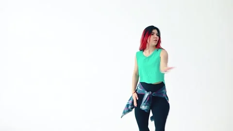 A beautiful dancer performs with red hair dances on a white background. Video stock 150899680