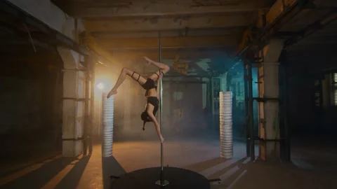 Beautiful dancer on a pole performs a scorpion trick. cyberpunk style Stock Footage 134744372