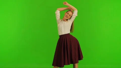 A beautiful dancer poses for the camera, spins and smiles, trying out her dress. Stock Footage 99609133