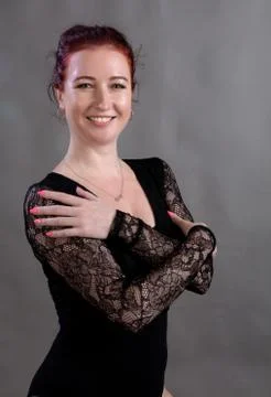 Beautiful dancer standing on grey background studio portrait. Stock Photos
