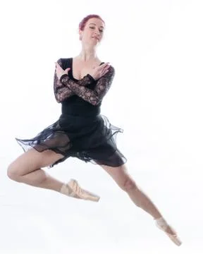 Beautiful dancer studio portrait stepping on white background. Stock Photos
