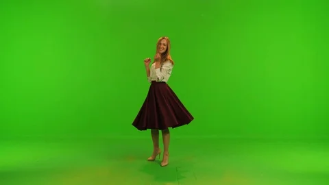 A beautiful dancer/actress poses for the camera, spins and smiles Stock Footage 99607879