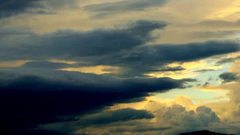 Beautiful dark background at sunset, clouds fly smoothly and quickly Slow motion Stock Footage 161438124