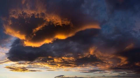 Beautiful dark cloudscape at sunset with red clouds Stock Photos