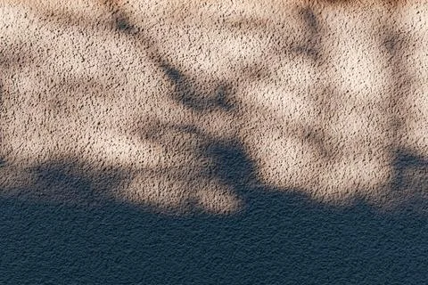 Beautiful dark grey plaster background with shadow pattern. Stock Photos