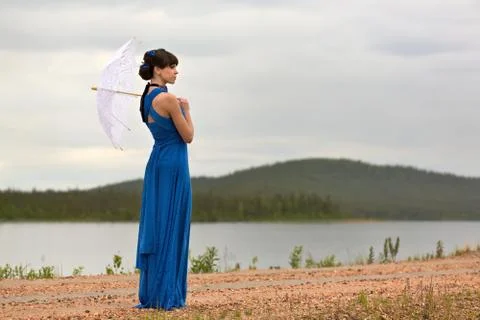 Beautiful dark haired model strolling through the woods. Stock Photos
