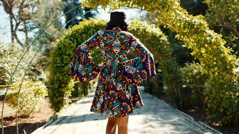 Beautiful dark skin model walking through the alley wearing South African style Stock Footage 184510568