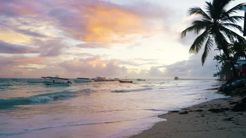 A beautiful dawn over waves lapping a Caribbean beach in Punta Cana Stock Footage 316244905