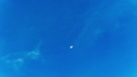 Beautiful Daytime Time-Lapse of Moon and Wispy Clouds in Deep Blue Sky Stock Footage 332297684