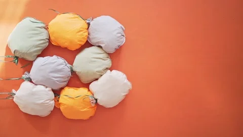 Beautiful decor on the orange wall. Multi-colored soft pillows in the photo zone Stock Footage 148730797