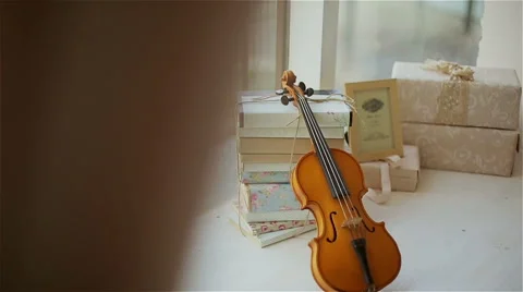 Beautiful decor in the studio, violin and books on the window Stock Footage 49743371