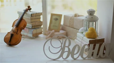 Beautiful decor in the studio, violin and books on the window Stock Footage 49743372