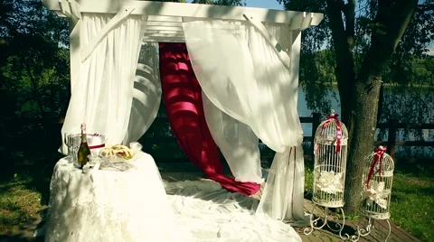 Beautiful decorated with light white chiffon chandelier and bouquets of roses Stock Footage 64771444
