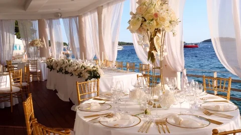 Beautiful decoration of the wedding table in white-gold colors, on the sea Stock Footage 124428074