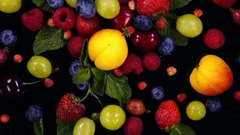 Beautiful decorative background with mixed berries and fruits and mint leaves 4K Stock Footage 78506028